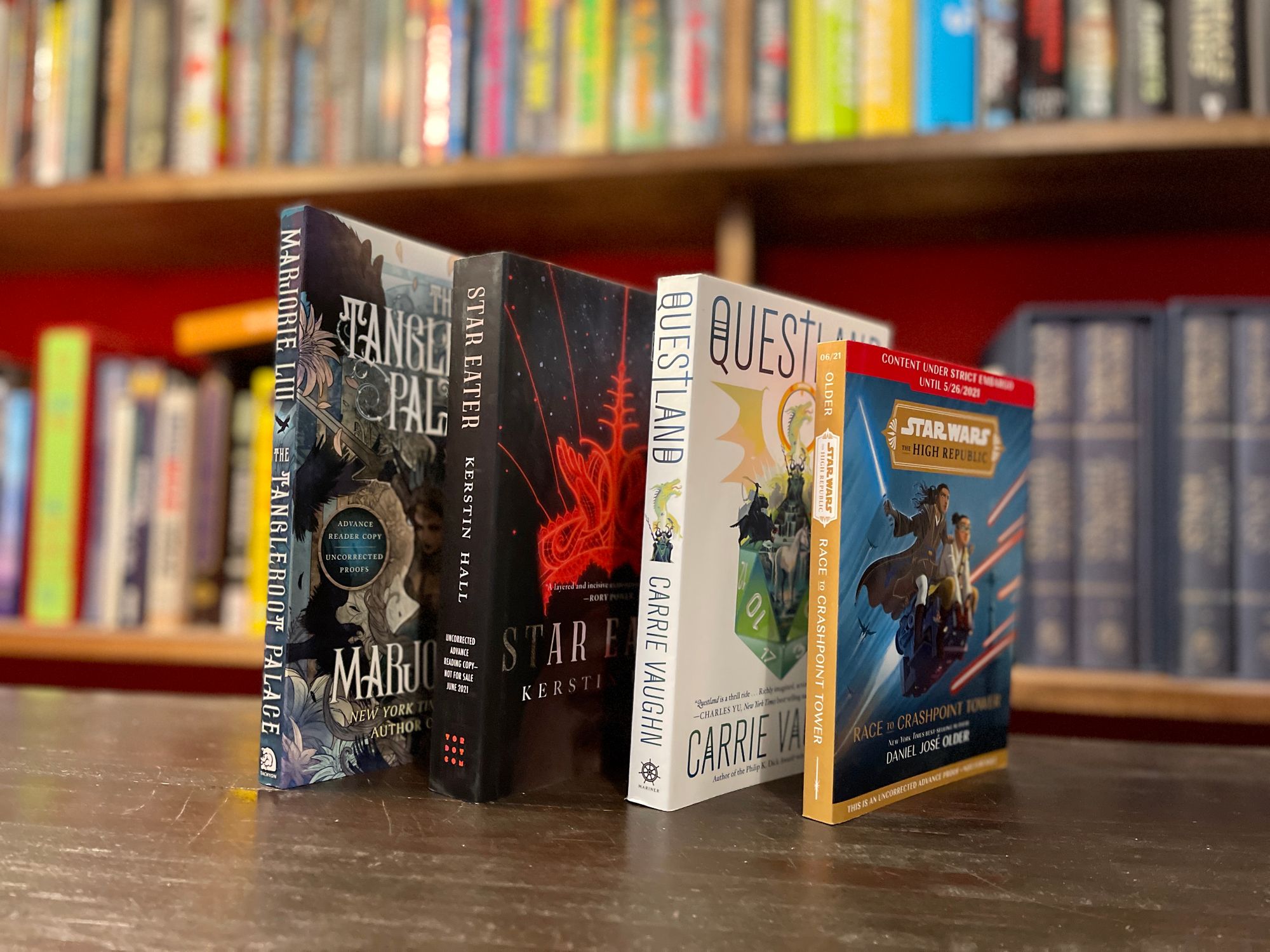 Four books standing spine out on a shelf.